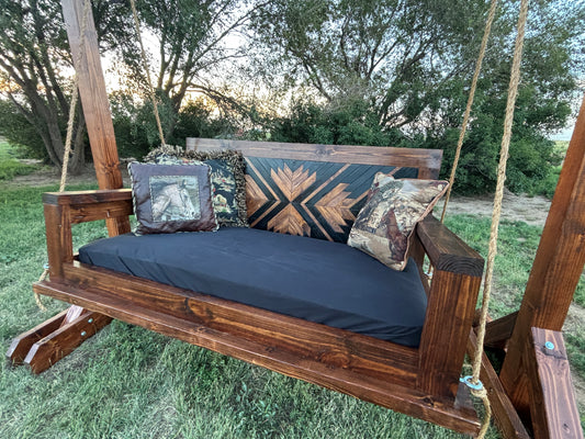 handcrafted wood porch swing dark walnut stain geometric backrest with cushion rope hardware Western farmhouse
