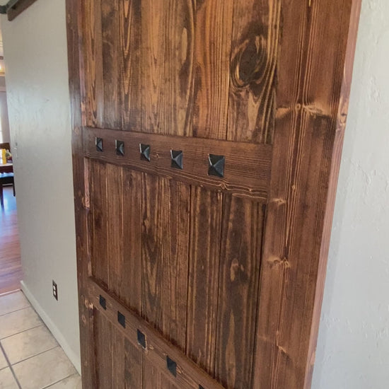 handmade sliding barn door installed in home dark walnut stain rustic farmhouse interior decor
