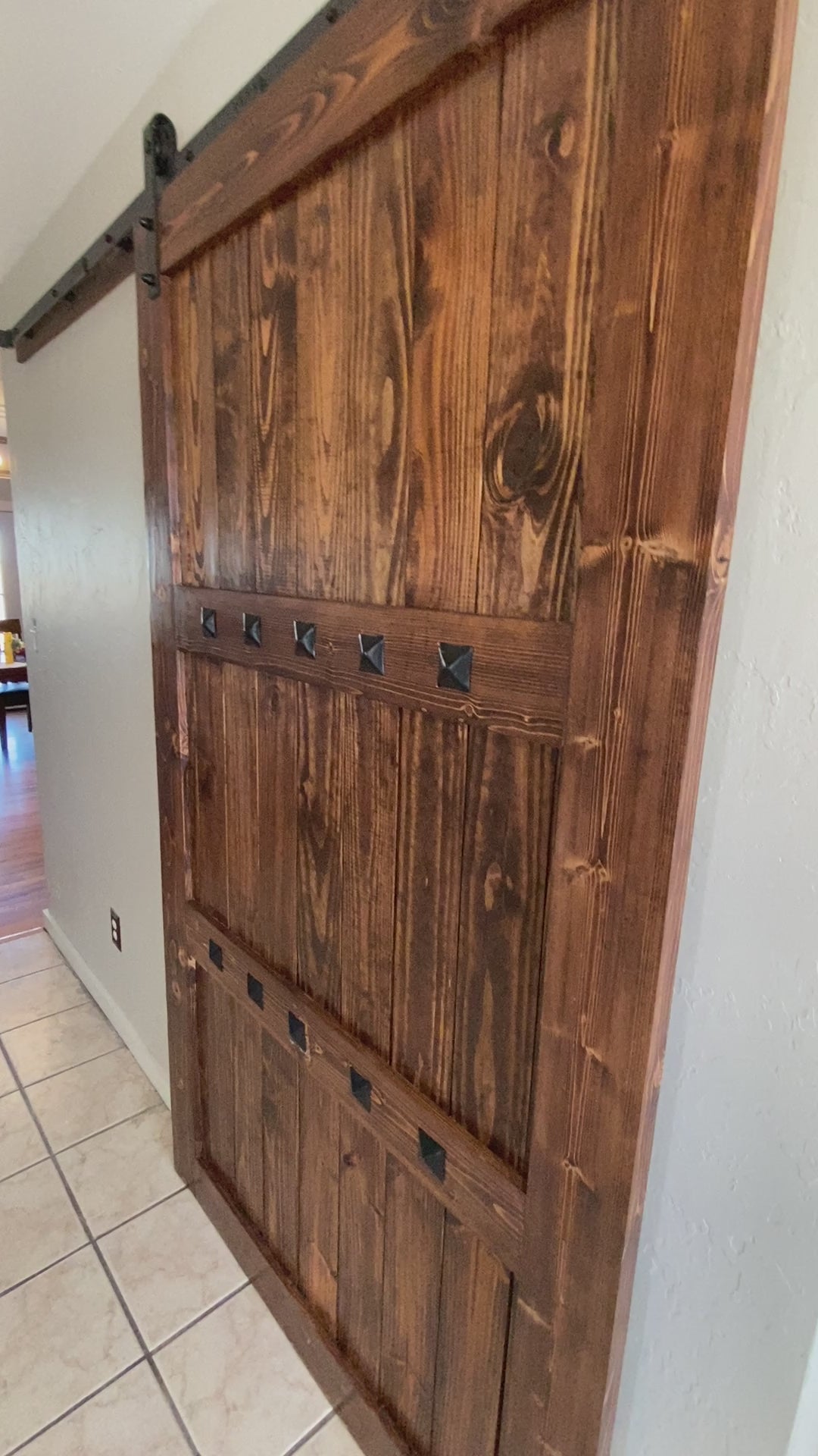 handmade sliding barn door installed in home dark walnut stain rustic farmhouse interior decor